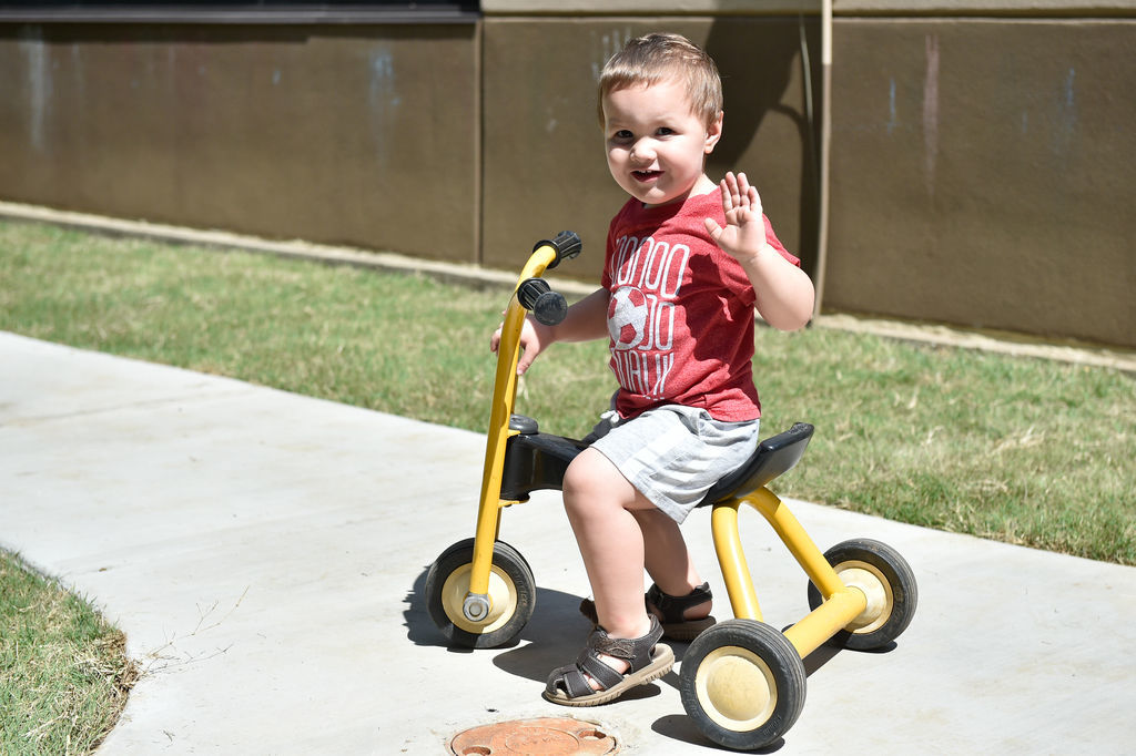 Children have fun on a newly built play area at Fred Moore Day Nursery School. Floyd Smith Concrete is the company that built the play area at Fred Moore Day Nursery School. The company is building it through a grant.
